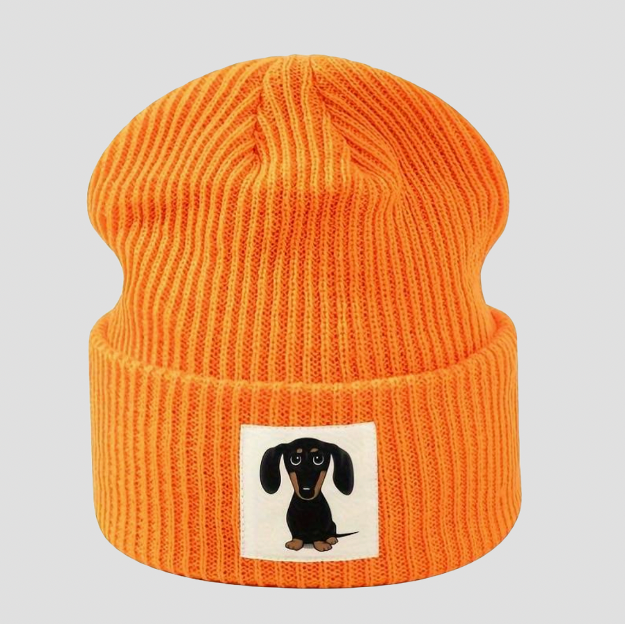 Orange knitted hat with cartoon dachshund patch